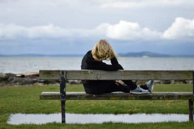 woman in black shirt sitting on bench
