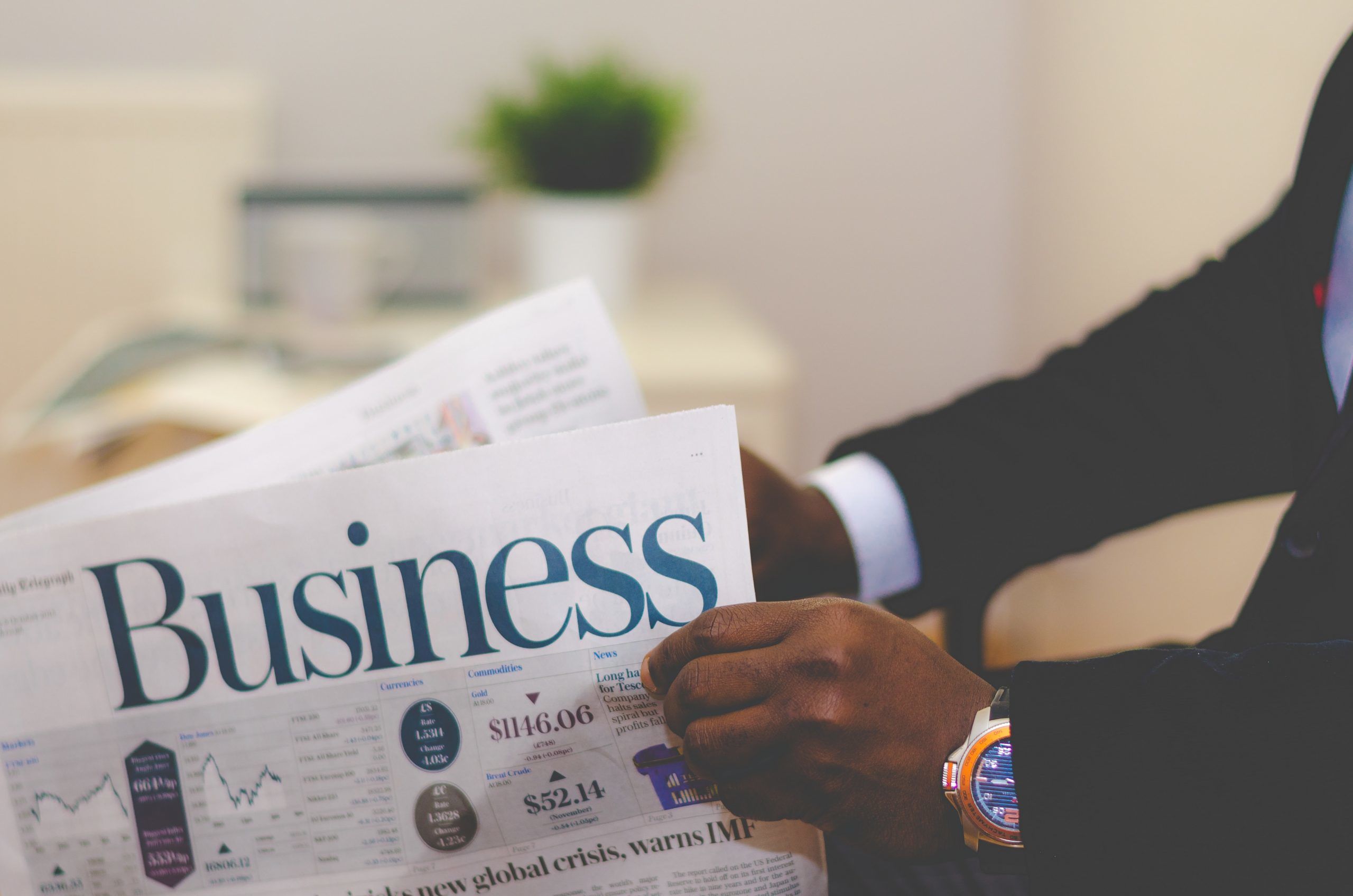 Challenges faced by small businesses and reasons why they should start accepting bitcoins! person wearing suit reading business newspaper