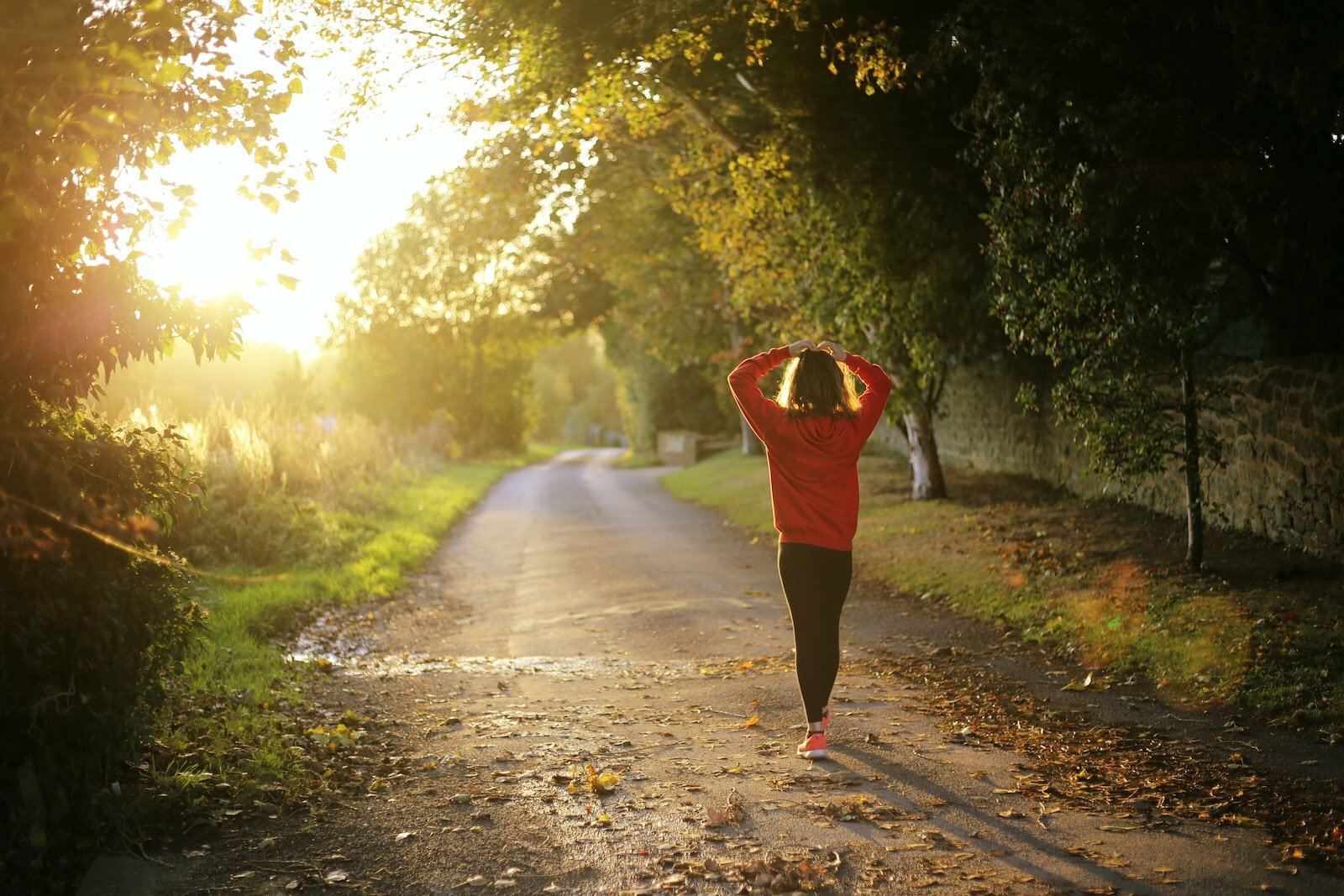How To Ace Your Wellness Goals During The Holidays woman walking on pathway during daytime