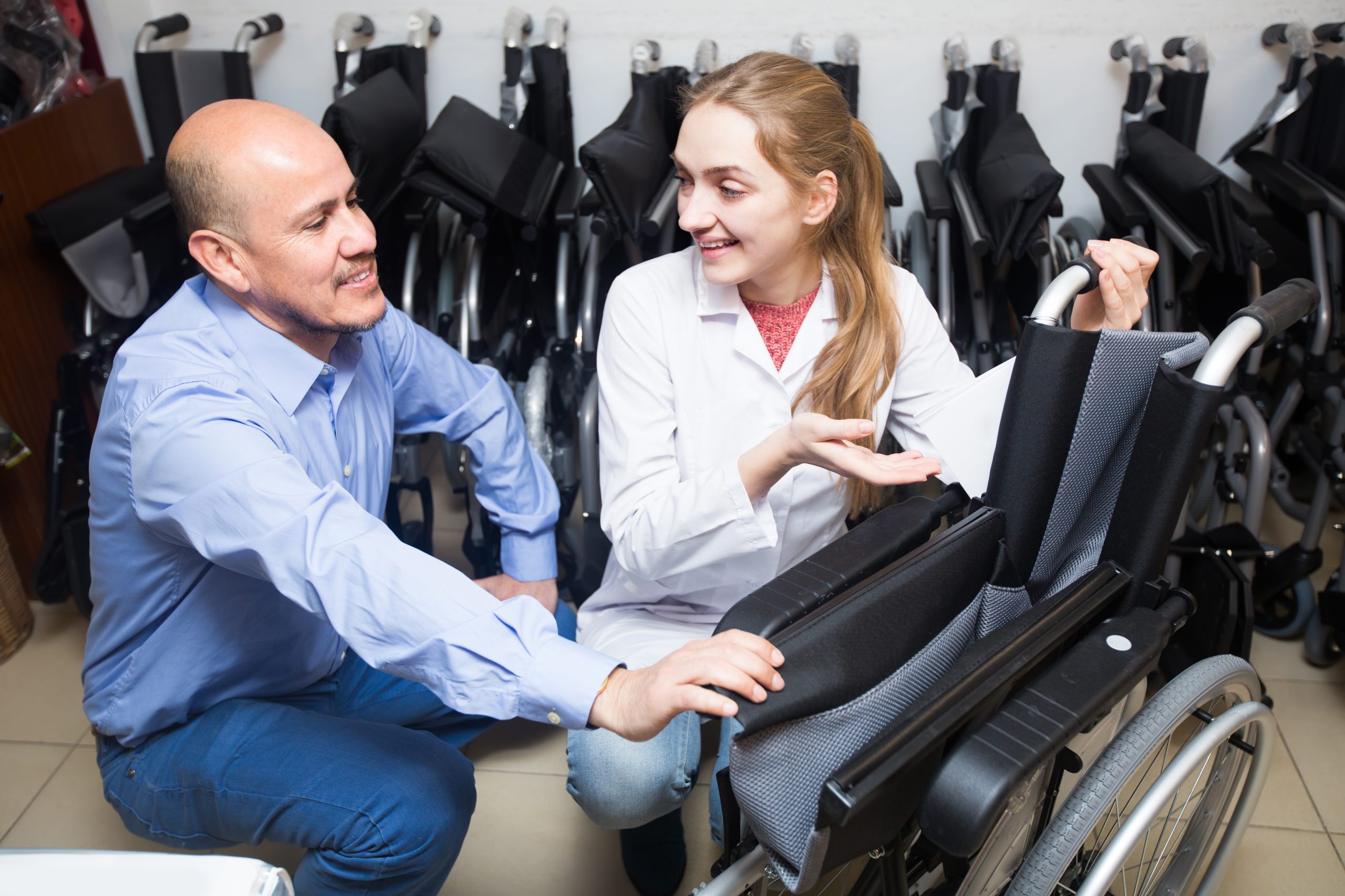 The Benefits Of Owning A Lightweight Foldable Wheelchair For Your Disability Consultant and customer in orthopaedic store