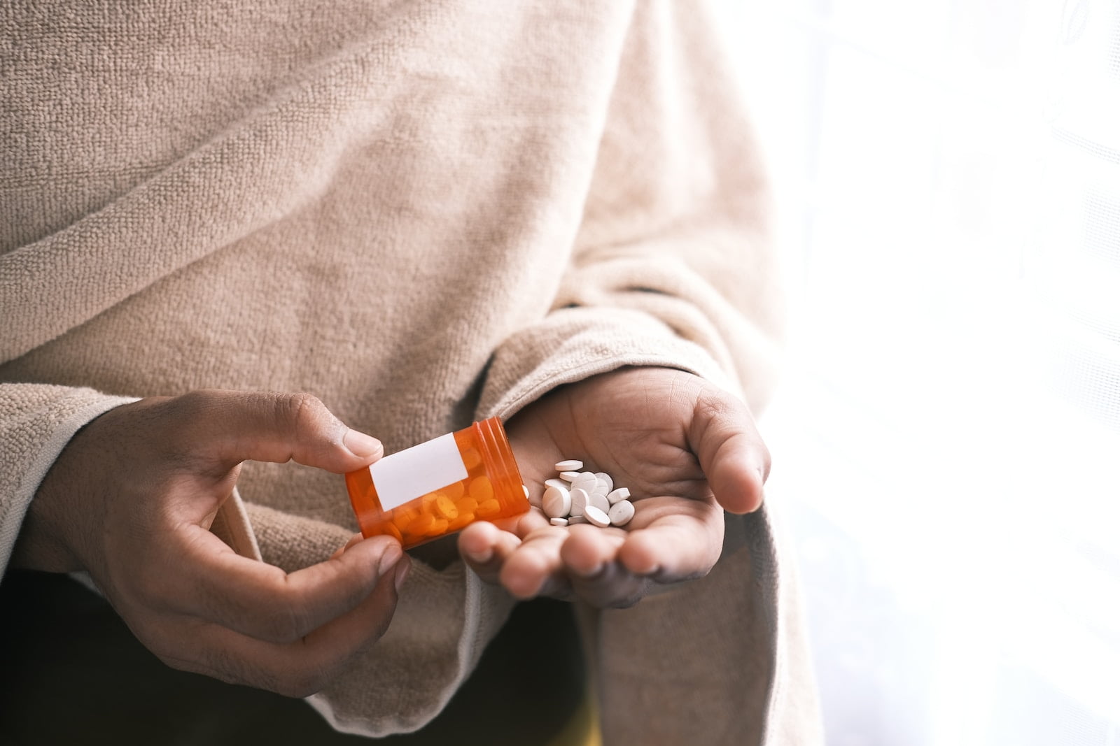 Addiction Treatment as Self-Improvement is a Journey Worth Undertaking orange and white plastic bottle on white textile