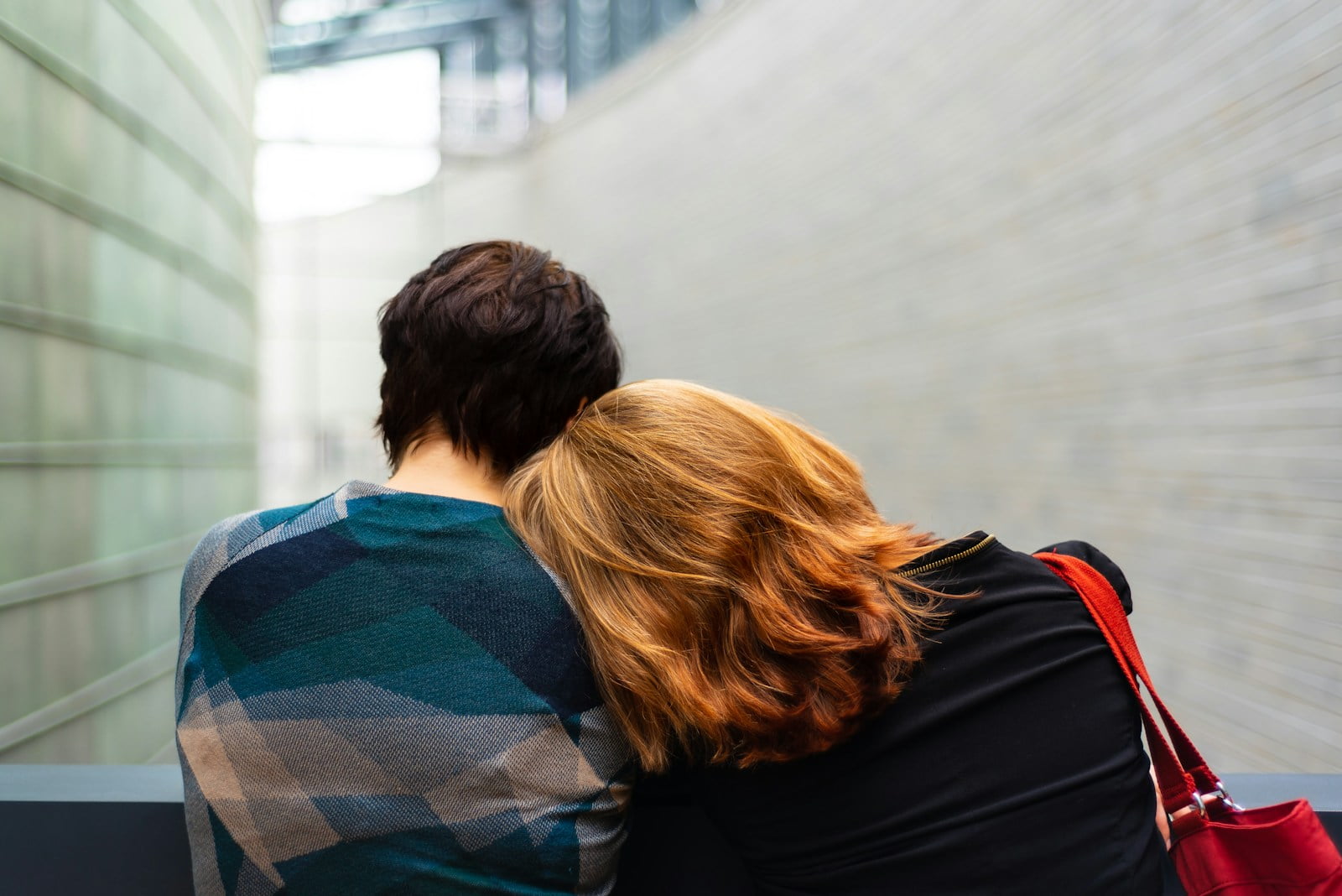 Addressing Emotional Abuse in Addiction Recovery a woman rests her head on another person's shoulder