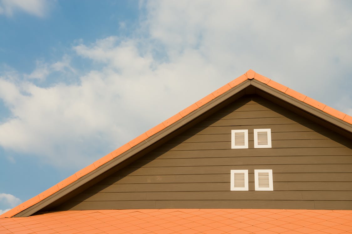 Things to Know Before You Get a New Roof Free Orange and Gray Painted Roof Under Cloudy Stock Photo