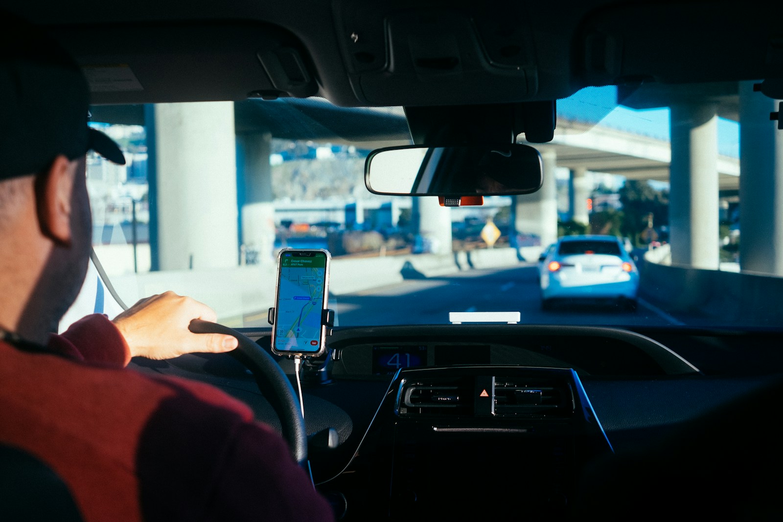How to Start Work as a Delivery Driver person holding iphone 6 inside car