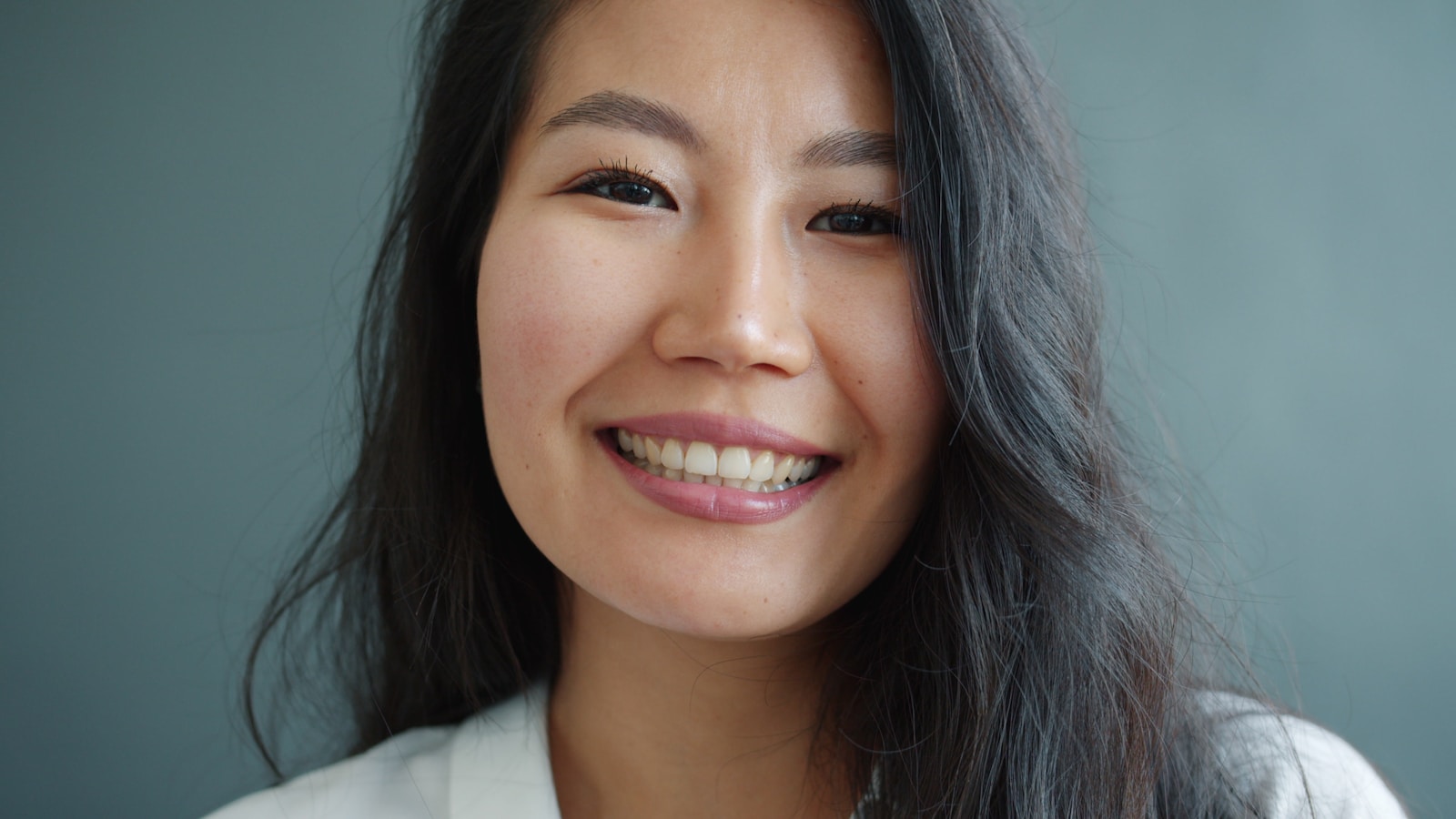 Why Preventive Dentistry Contributes To A Better Quality Of Life A smiling asian woman with dark hair