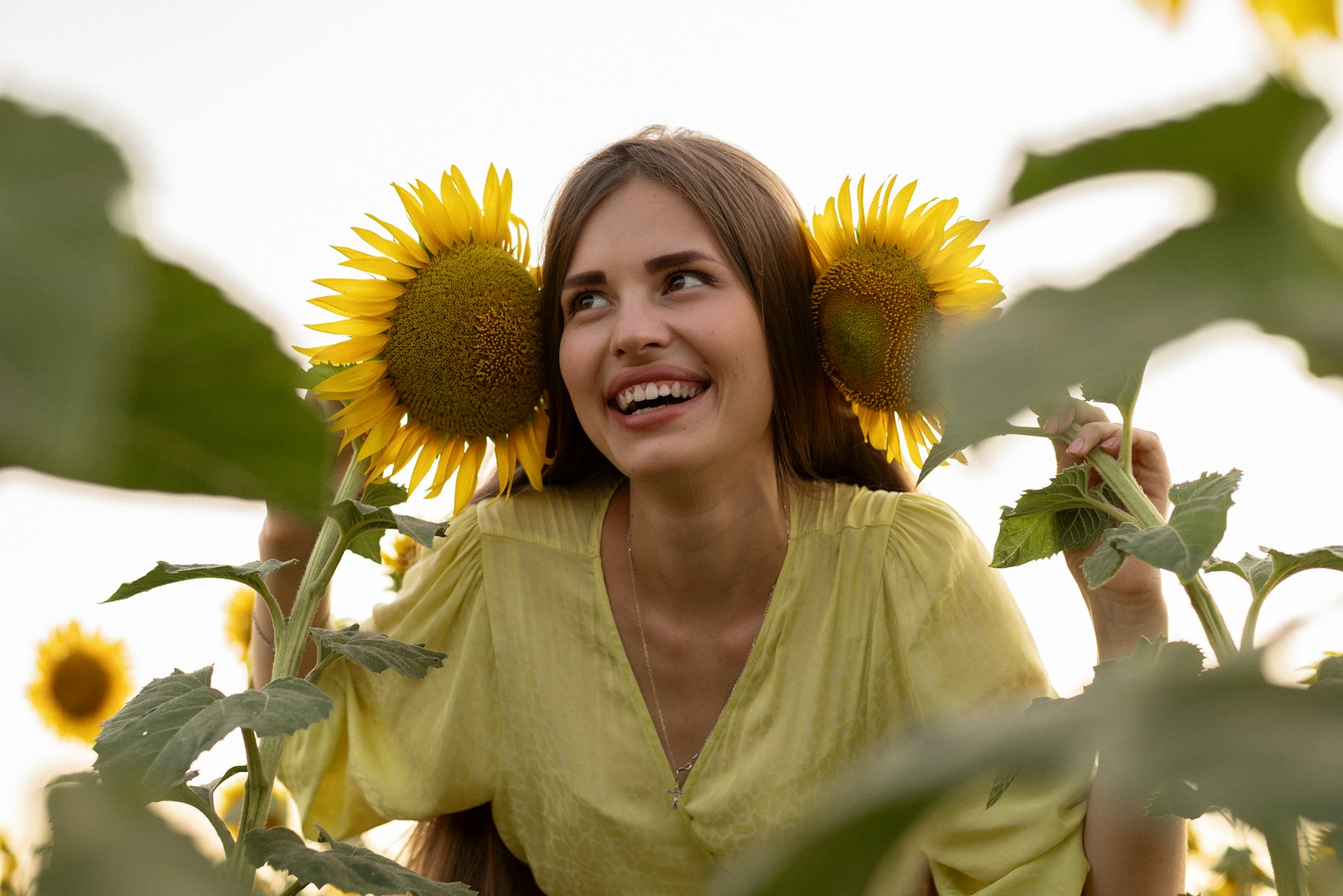 Why Family Dentistry Improves Communication About Oral Health At Home A woman standing in a field of sunflowers