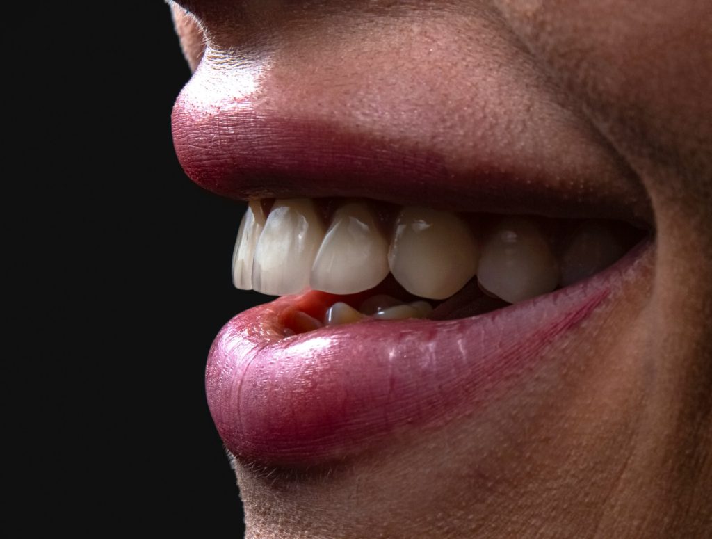 a person's mouth with teeth and tongue sticking out