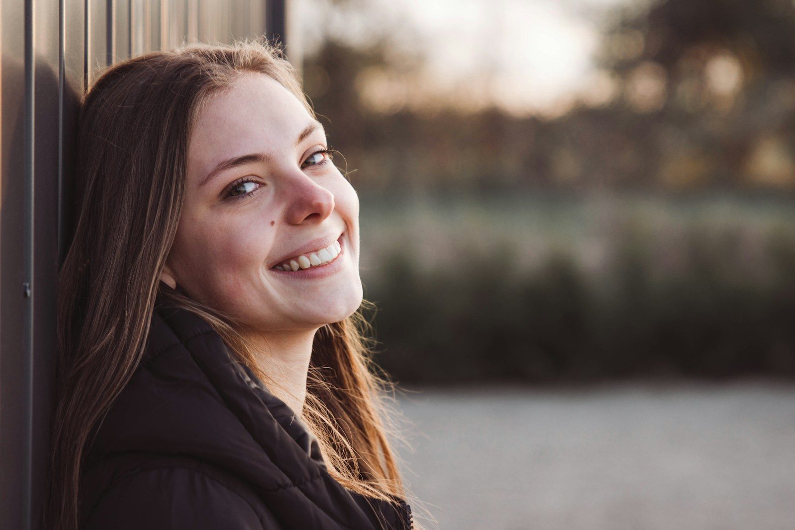 Why Preventive Dentistry Strengthens Outcomes For Smile Transformations a woman smiling outside