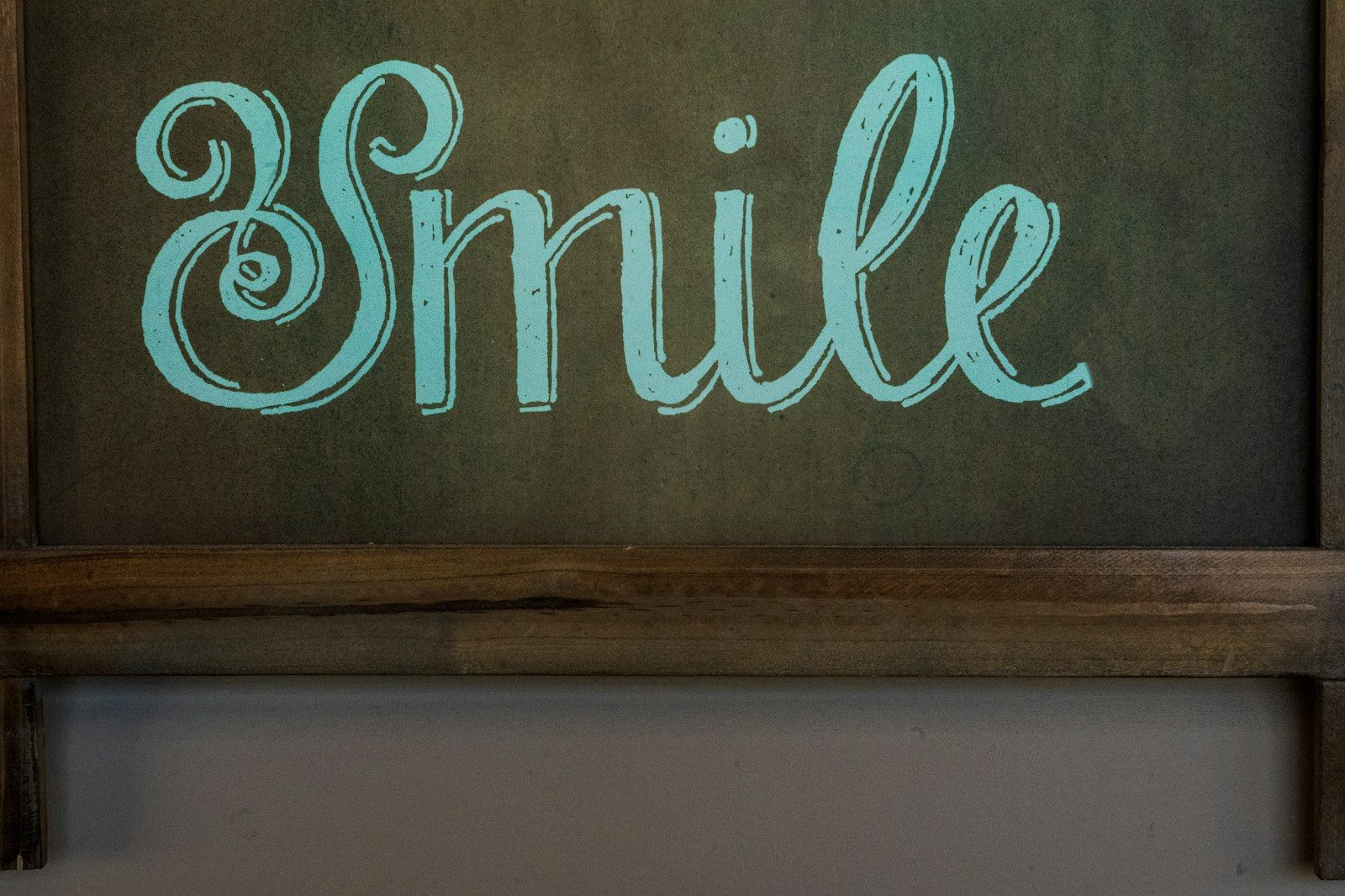 How Family Dentistry Builds The Foundation For Cosmetic Enhancements brown wooden wall mounted signage