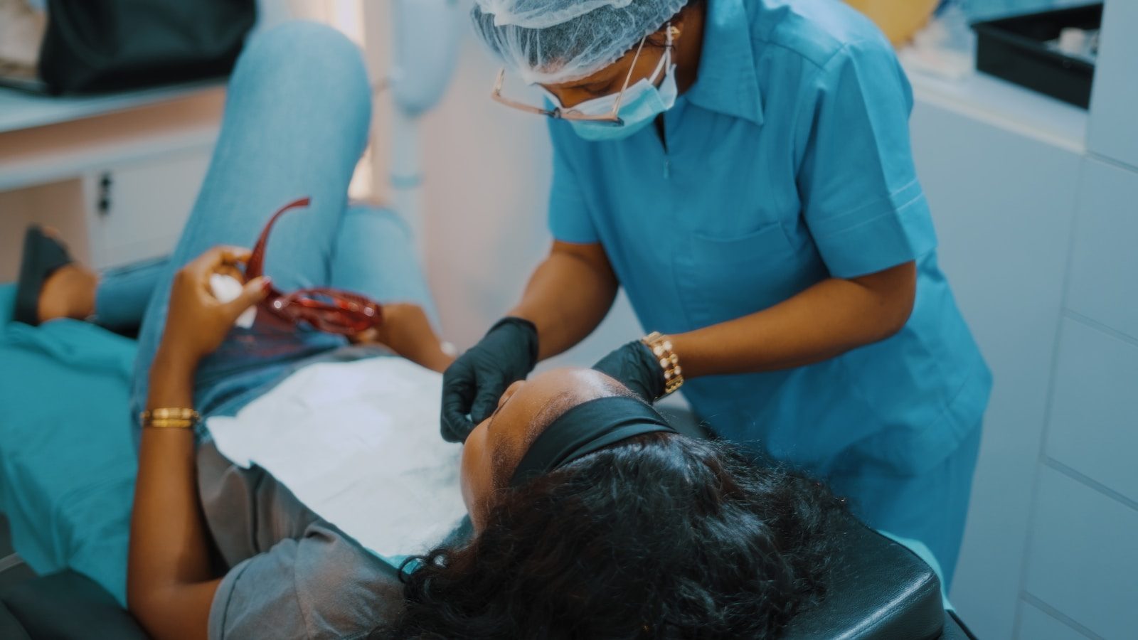 3 Reasons Preventive Dentistry Protects Cosmetic Dental Investments a woman getting her teeth checked by a dentist