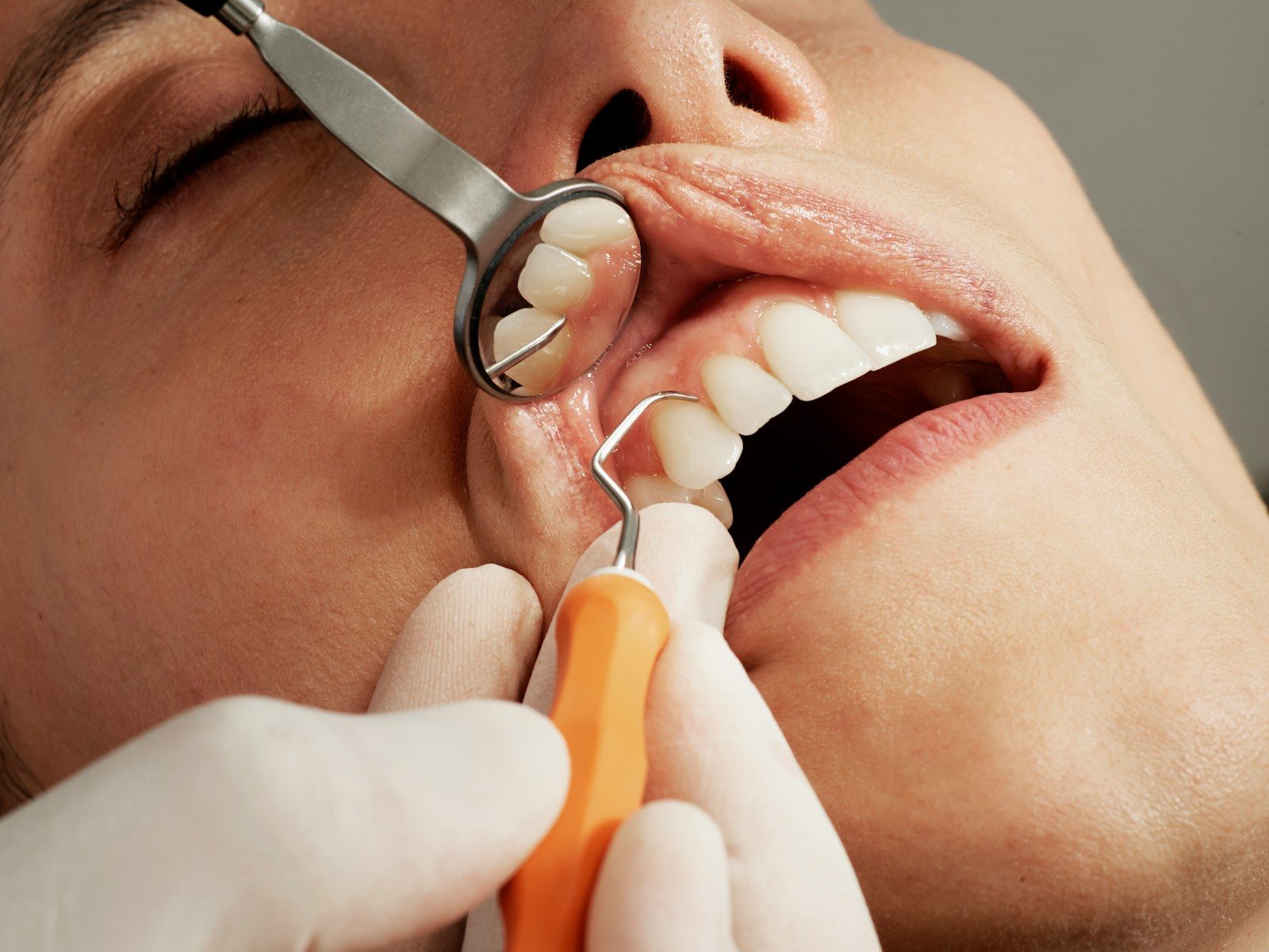 4 Benefits Of Combining Preventive And Aesthetic Dental Care dental exam with mirror and tool