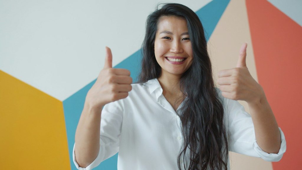Woman giving two thumbs up with a smile